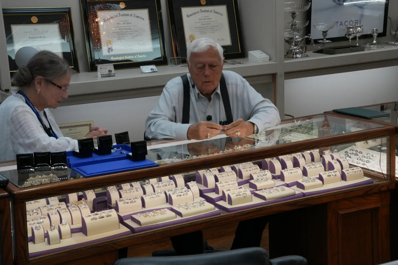 The owners of O'Neal's Jewelers seated at their display counter during an on-camera interview