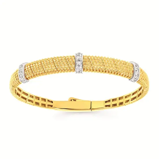 Yellow gold bangle bracelet with a textured finish and three diamond-set bars